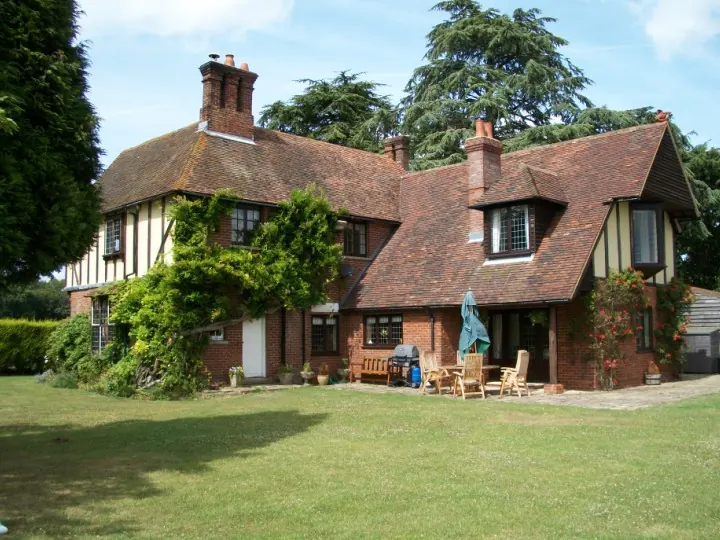 Extended period house in Kent with a peg-tiled roof, timber framing and a large lawn