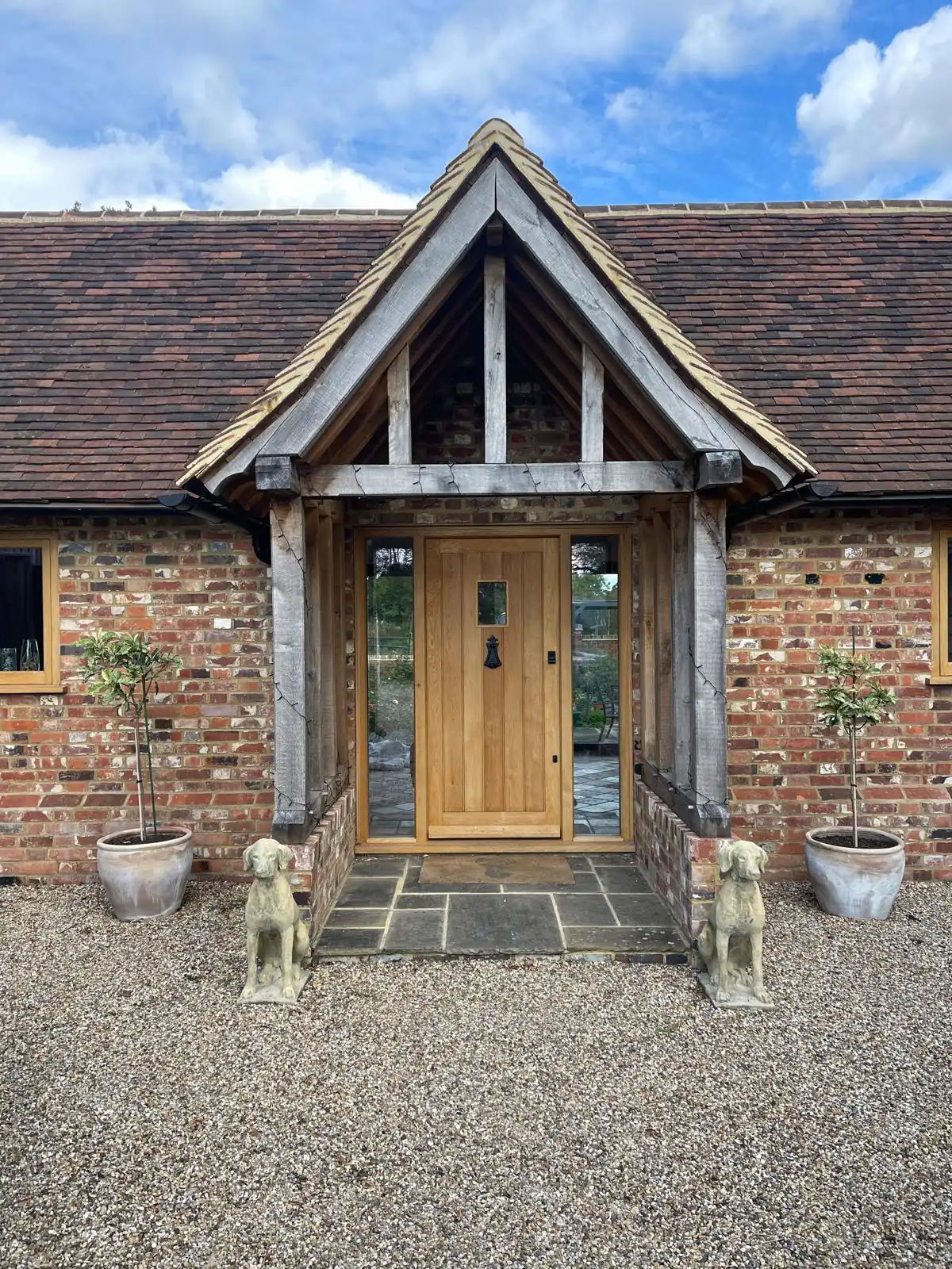 Oak framed porch on a brick cottage