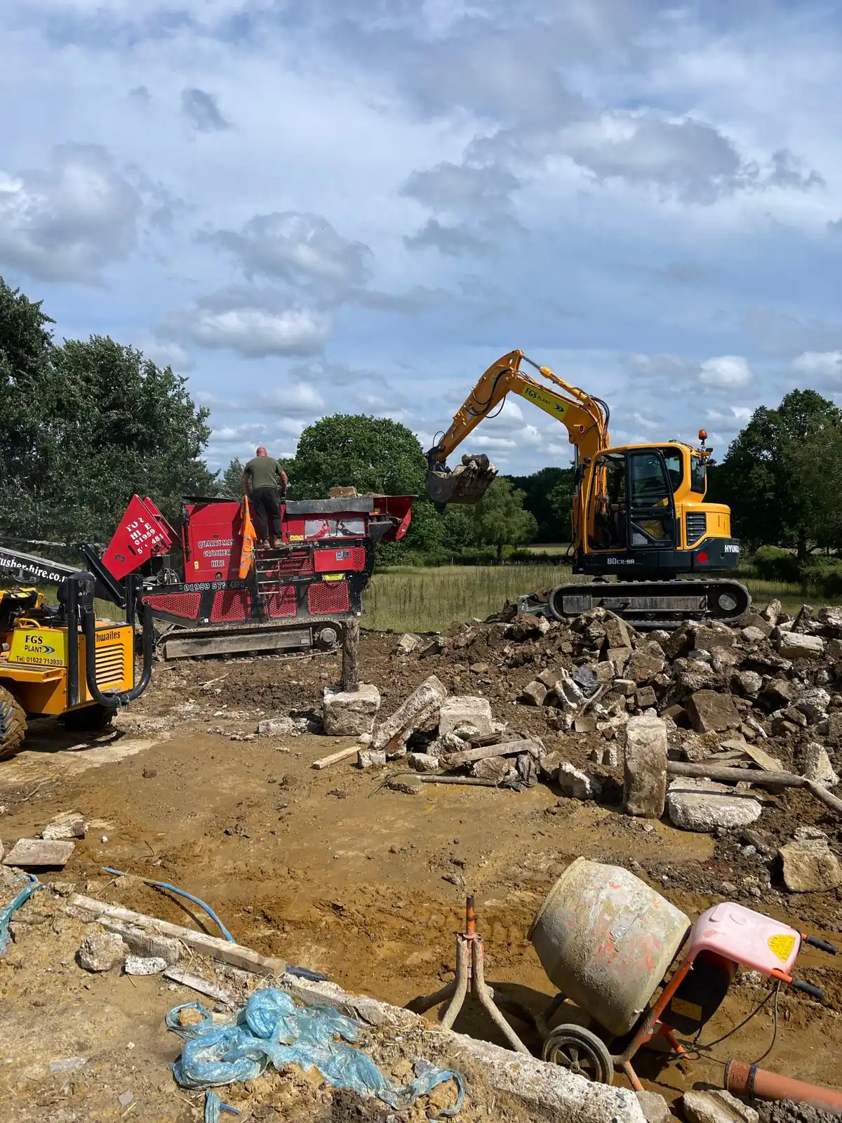 Excavator and crusher working on site