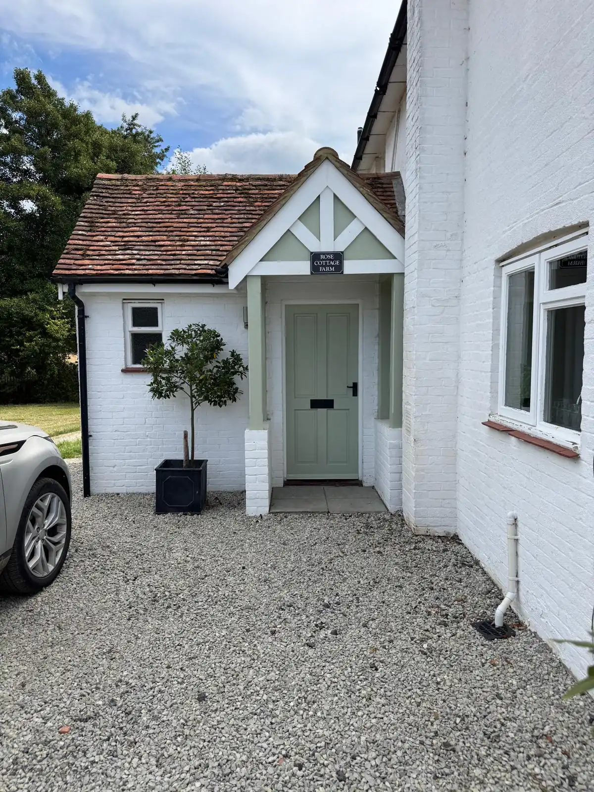Freshly painted white cottage with a tiled porch