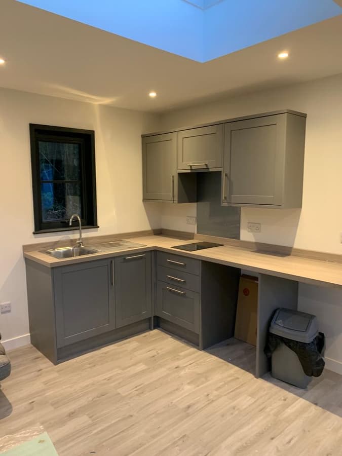 Fitted grey kitchen under a rooflight