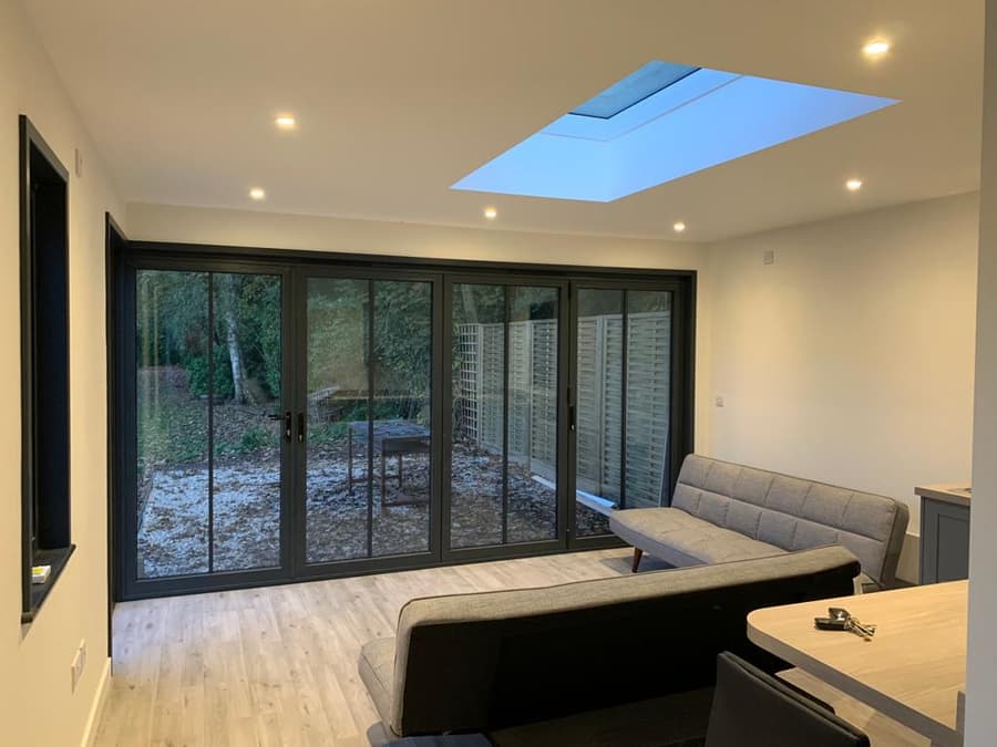 Living room with bifold doors and a rooflight
