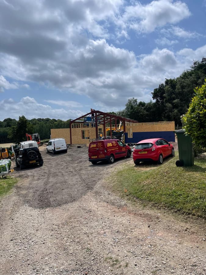 The site at the start, with the frame going up beyond the parked cars