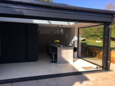 Kitchen seen through the open glass doors
