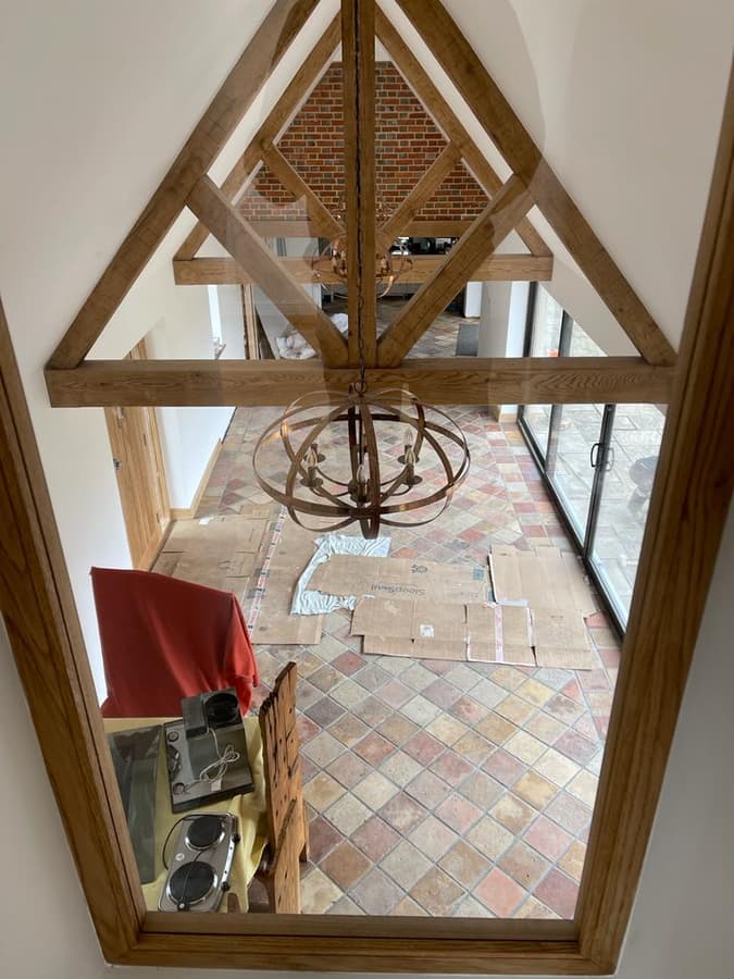 Oak-framed hallway reflected in a tall mirror