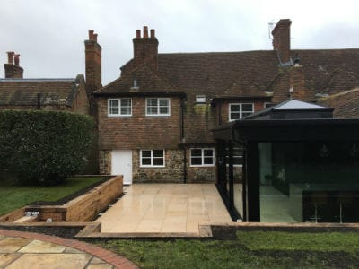 The glass extension against the old brick house