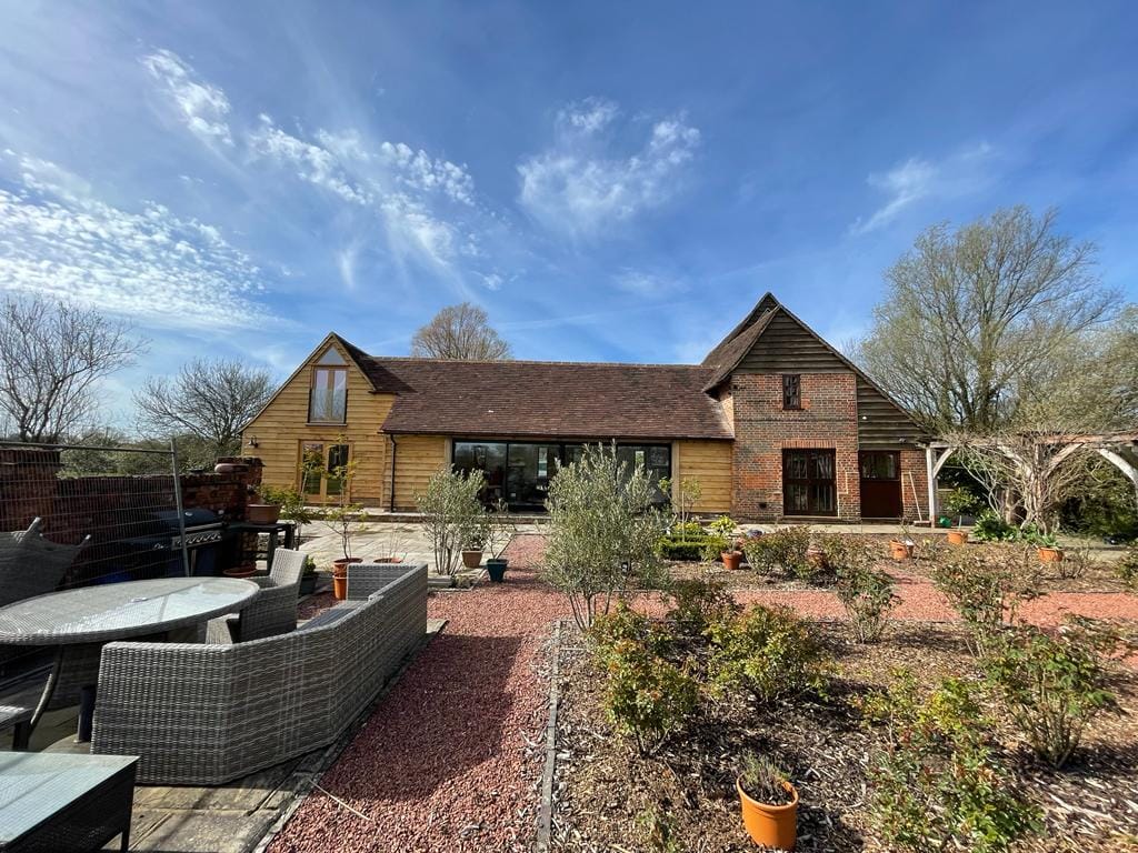 The oak barn home seen from the garden