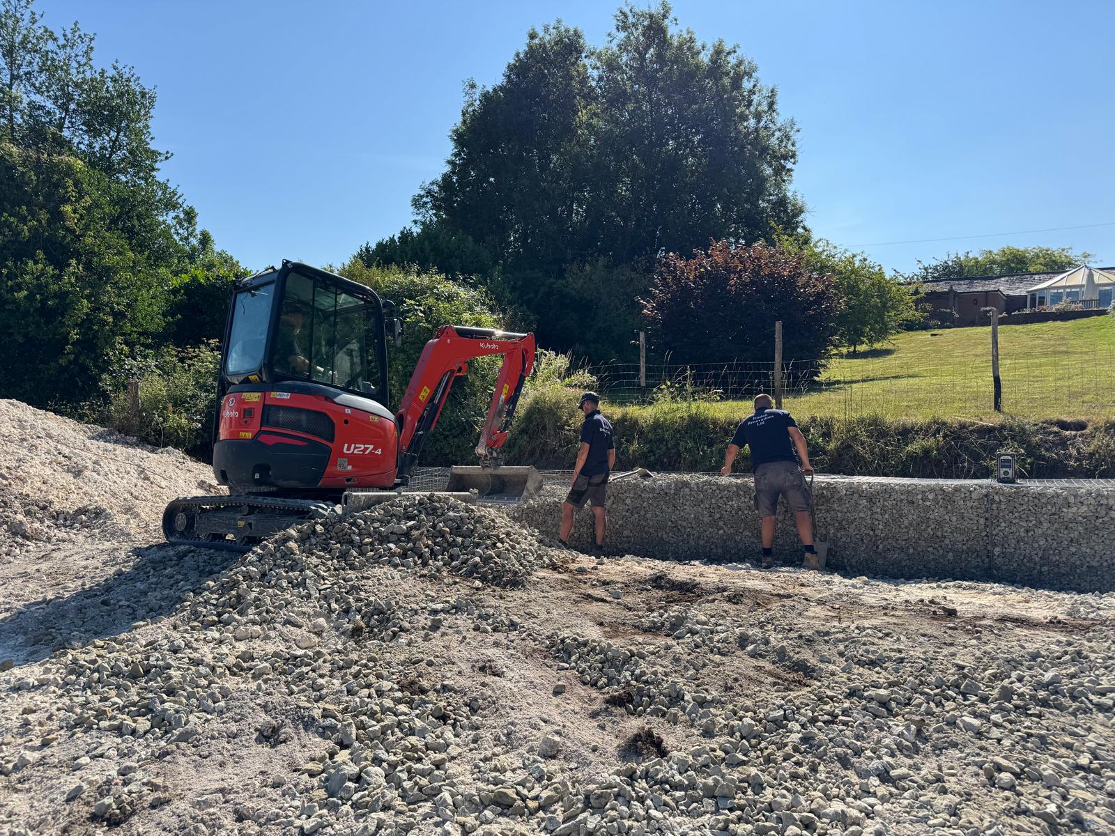 Risdon team and excavator building a retaining wall · the build