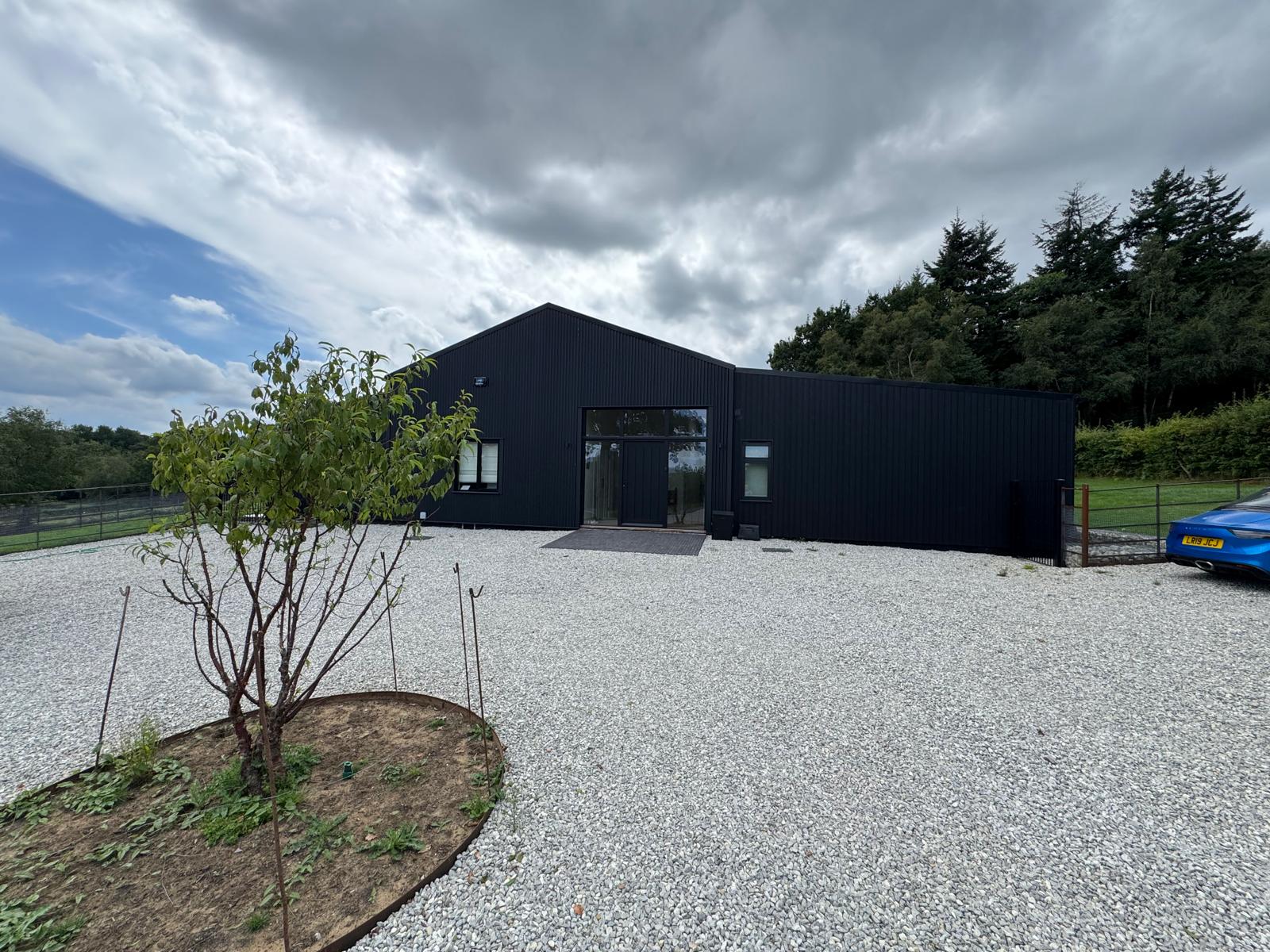 Black-clad modern barn new build · the design